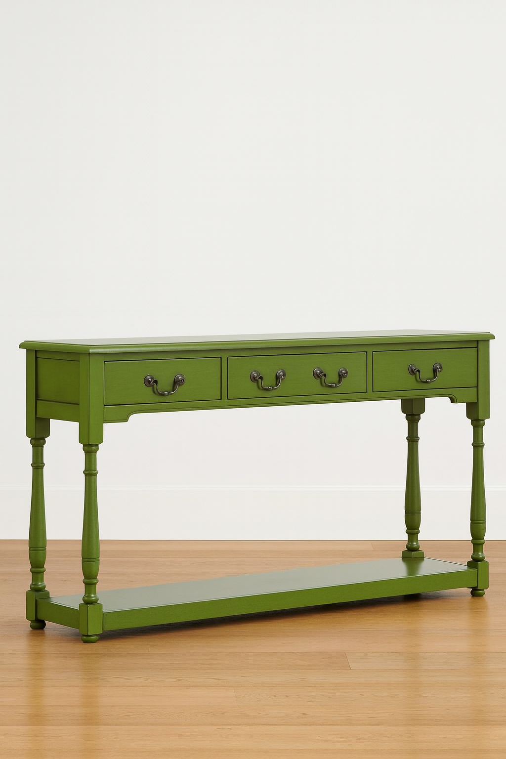 Green console table with three drawers on a wooden floor.