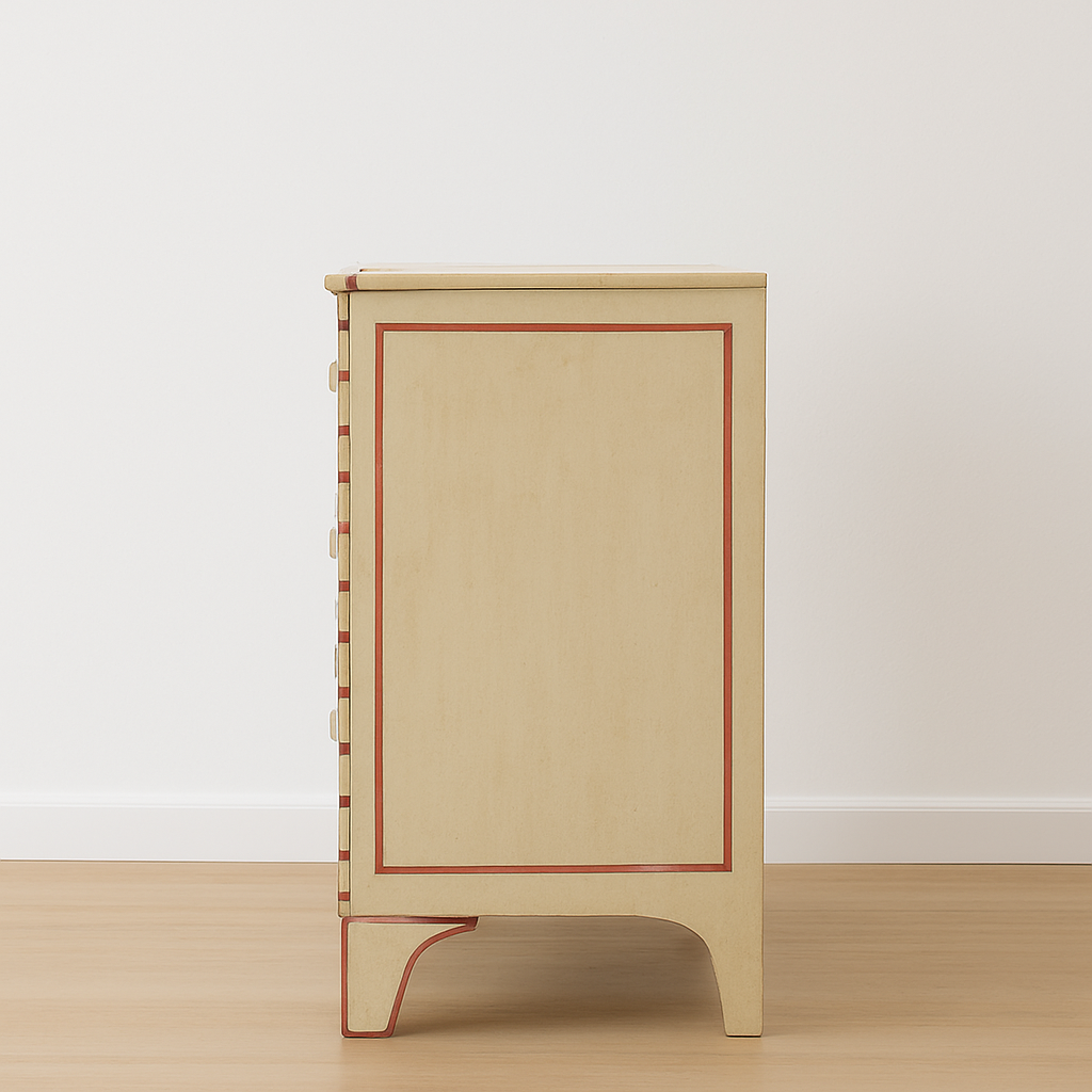 Beige side table with red accents on a wooden floor and white wall background