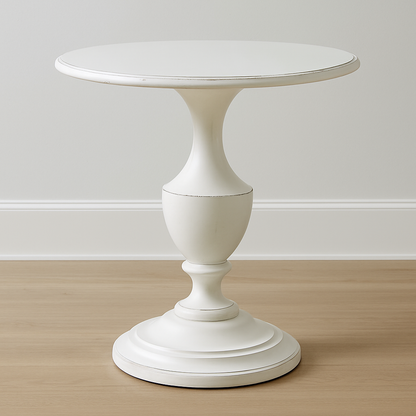 White pedestal table against a plain wall